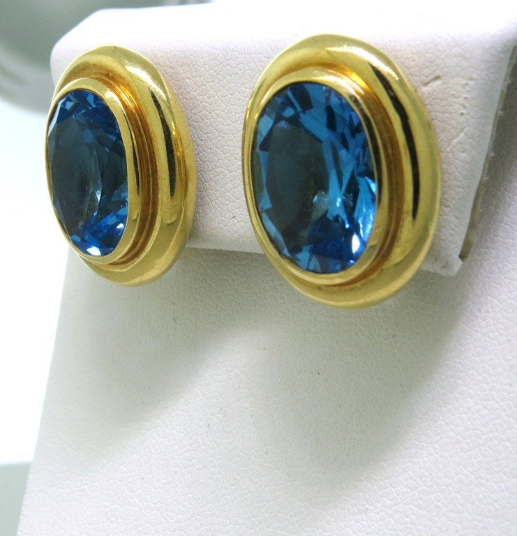 18k yellow gold, heavy bezel set faceted blue topaz stones.
Approx. total weight 25.00 ctw. earrings - 24mm X 18mm. Weight- 21.4g