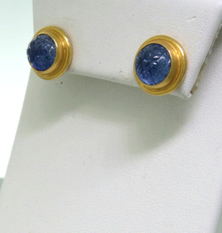 22k yellow gold stud earrings bezel set with carved blue sapphires. Earrings 12mm in diameter. sapphires approximate 4.00ctw total weight .