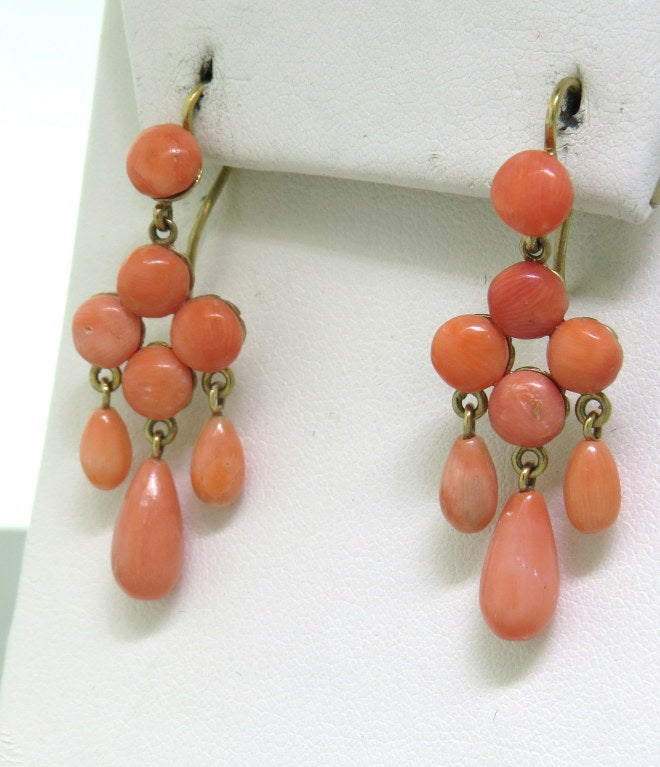 14k yellow gold, coral, 41mm long.
 weight: 5.9g