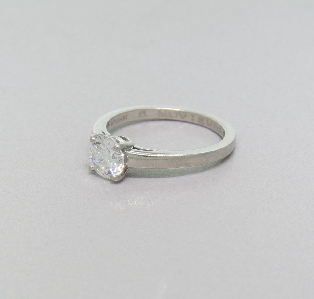 Maker: Bulgari
Diamond - 1.01ct 
Color Grade - E
Clarity Grade - VS1
Ring Size 7, Shank - 2.2mm Wide
Weight - 5.0g
Marked: Bulgari, Made In Italy, Italian Assay Marks, 950, 49976

Engraved on Interior: 