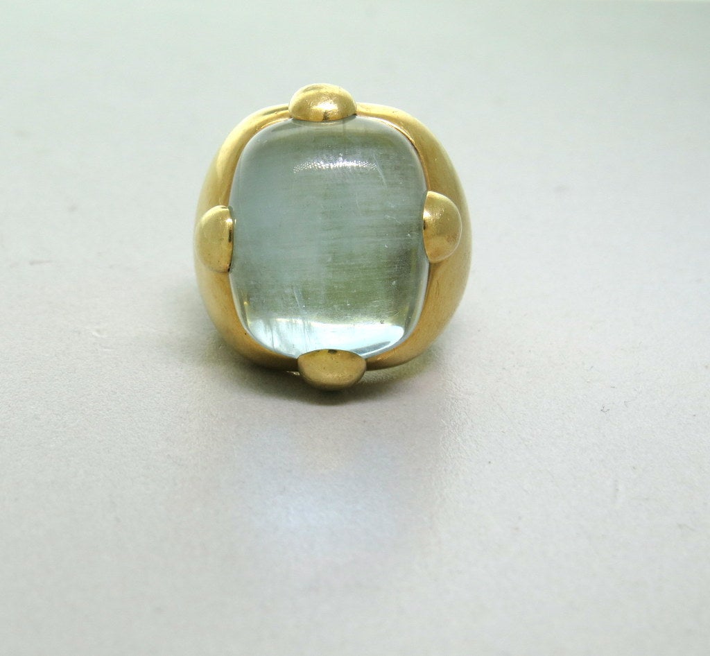 Pomellato 18K gold ring with aquamarine cabochon center measuring 15.5mm x 19mm. Ring size 7, Ring is 25mm at widest point. Marked - Pomellato, 750. Weight - 25.0g