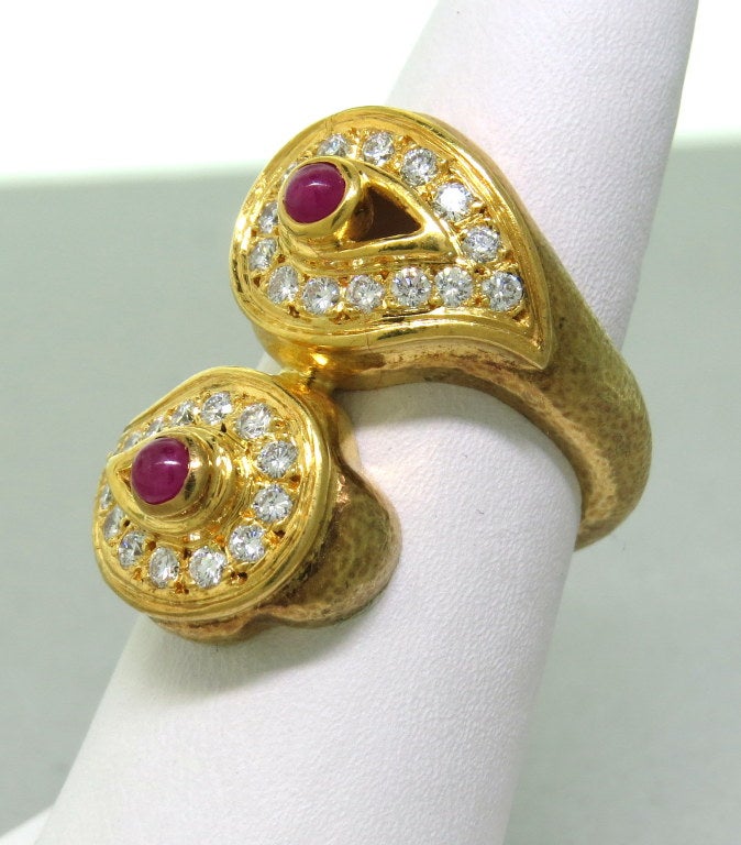 Zolotas 22K yellow gold ring featuring ruby cabochons and approximately 0.70-0.75ctw of diamonds. Ring size 7 and 28mm at widest point. Marked - Zolotas, K22. Weight -13.4g