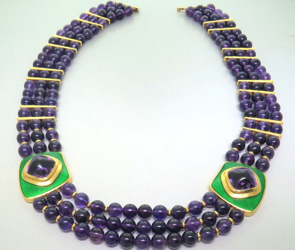 Leo De Vroomen 18k yellow gold necklace featuring two sugar loaf cut amethyst 13mm x 13mm, surrounded by green enamel and three rows of amethyst beads measuring 7mm in diameter. Shortest strand is 17