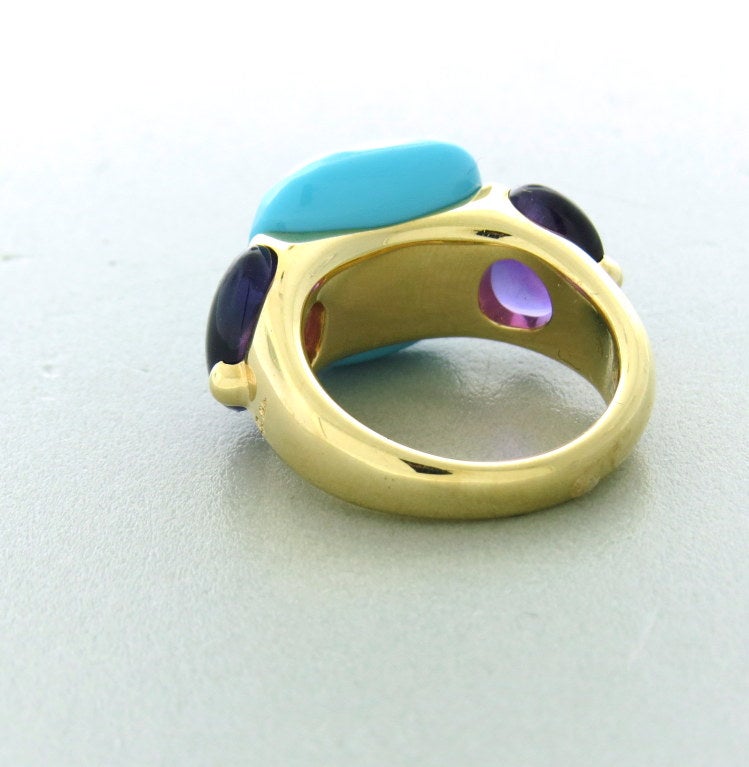 Pomellato 18k rose gold ring from Capri collection,with two side amethyst cabochons and faceted center turquoise. Approximate retail is $7220. Ring size 7 1/2, ring top is 15mm x 25mm. Marked with Pomellato,750. weight - 15.5g