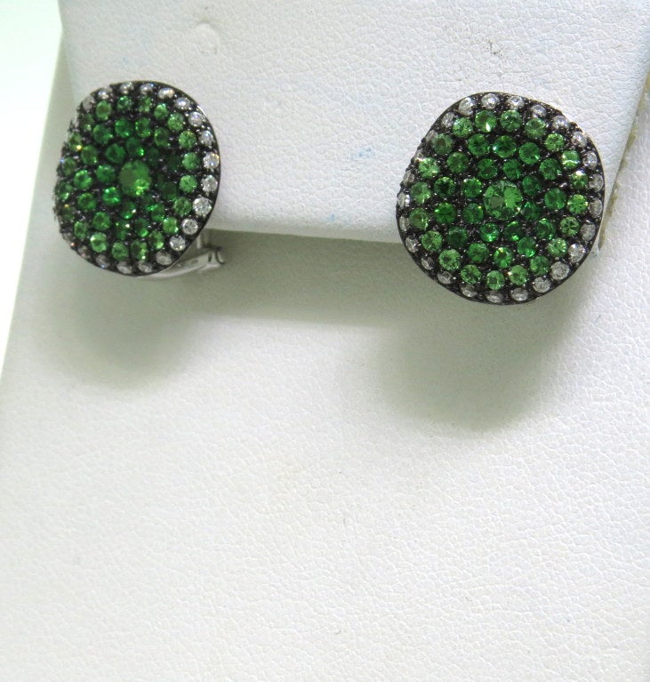 Modern 18k white gold earrings with approx. 2.00ctw tsavorite and 0.60ctw diamonds. Earrings are 16mm x 15mm. Weight - 9.7g