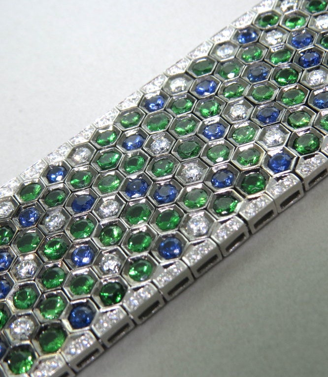 Impressive modern 18k gold bracelet by Salavetti, with 6.64ctw G/VS diamonds and a total of 23.31ctw sapphires and green garnets.  Retail $74,000. Marked 750,Salavetti. Bracelet is 6 6/8