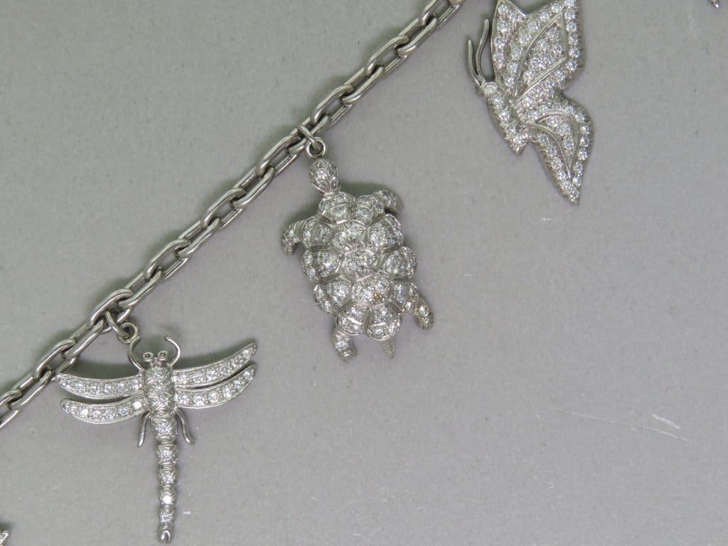 circa 1996 Tiffany & co complete charm bracelet . Metal:950 platinum.
 Link bracelet with 7 platinum charms set with diamonds. 7