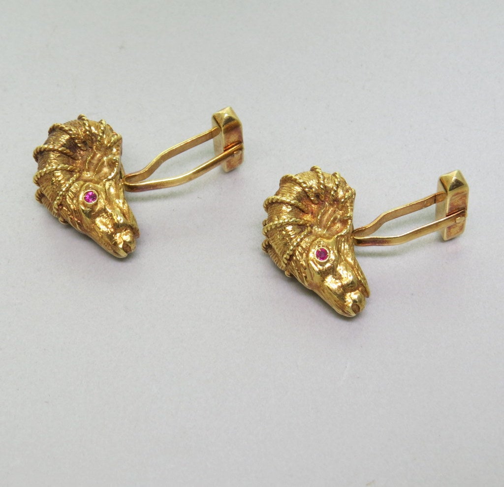 18K Yellow gold rams head cufflinks featuring rubies. Cufflinks are 23mm x 14.5mm at widest point. Cufflinks are marked 750. Weight - 28.0g