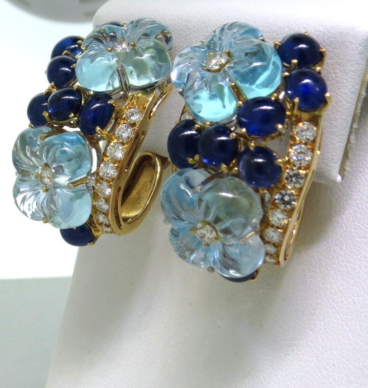 18k yellow gold earrings with carved light blue topaz flowers, approx. 4 - 4.20ctw sapphire cabochons and 2 - 2.10ctw diamonds. Earrings are 34mm x 24mm. weight - 35.4g