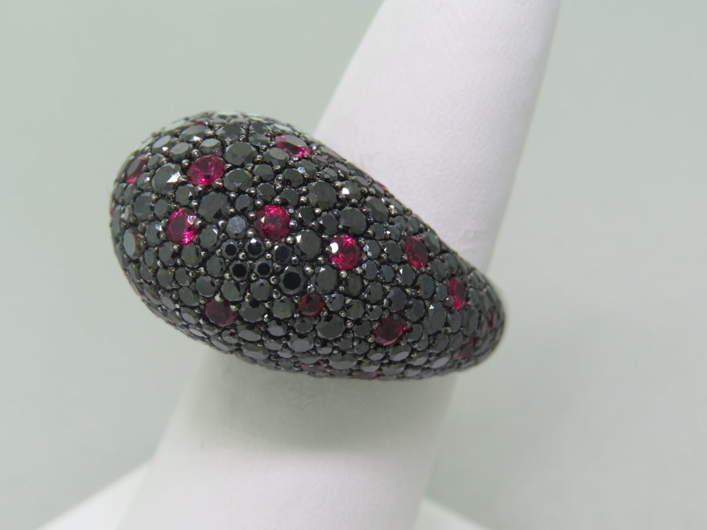 Modern 18k gold ring with 7.68ctw black diamonds and 1.77ctw rubies. Ring size 6 1/2, ring top is 16mm x 25mm, ring sits 16mm from the finger. Weight - 20g.