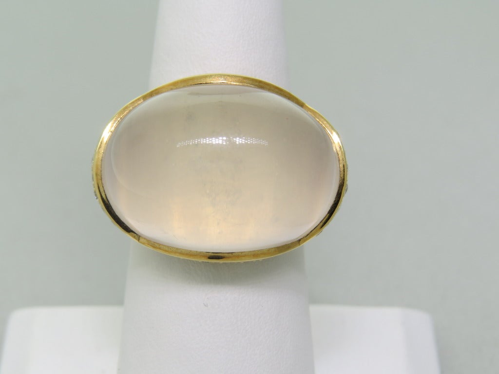 18k yellow gold ring with 30.37ct milky quartz and 0.74ctw diamonds. Rings size 7 1/4, ring top is 18mm x 26mm. weight 21.4g