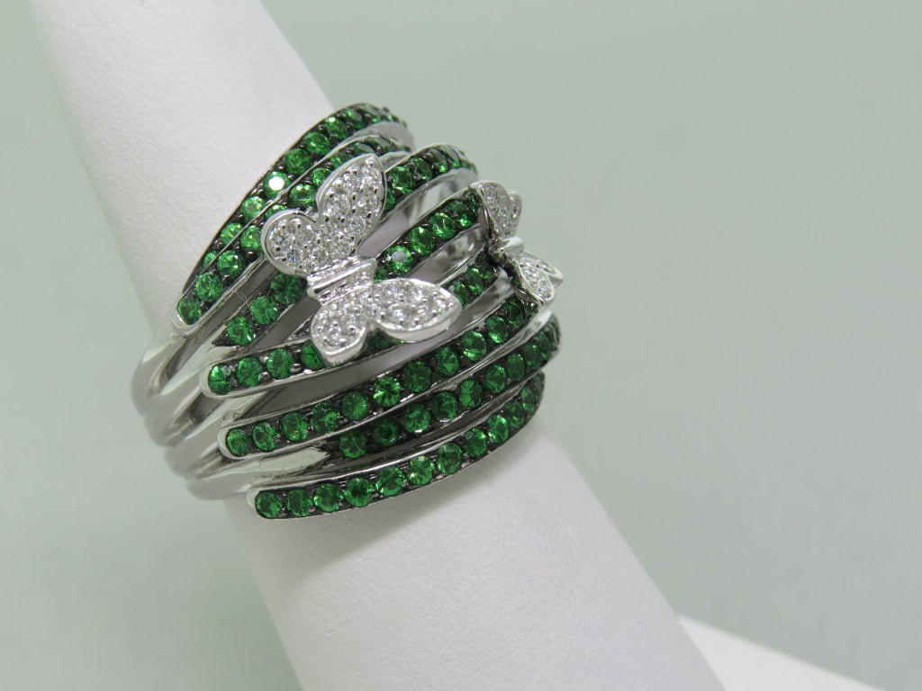 18k white gold ring with 0.20ctw butterflies and 2.65ctw tsavorite. Ring size 6 1/2, ring is 20mm at widest point. 15.7g