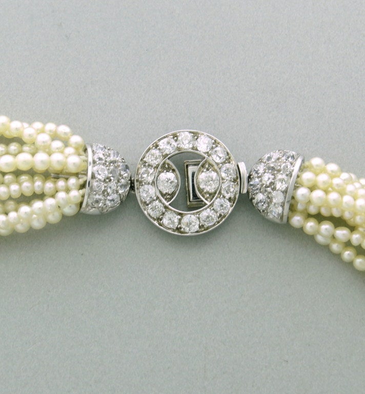 Antique platinum multi strand pearl necklace with old mine cut diamond clasp. Diamonds approx,. 2.80ctw. Pearls - 2.4mm to 3.5mm in diameter. Necklace is 16