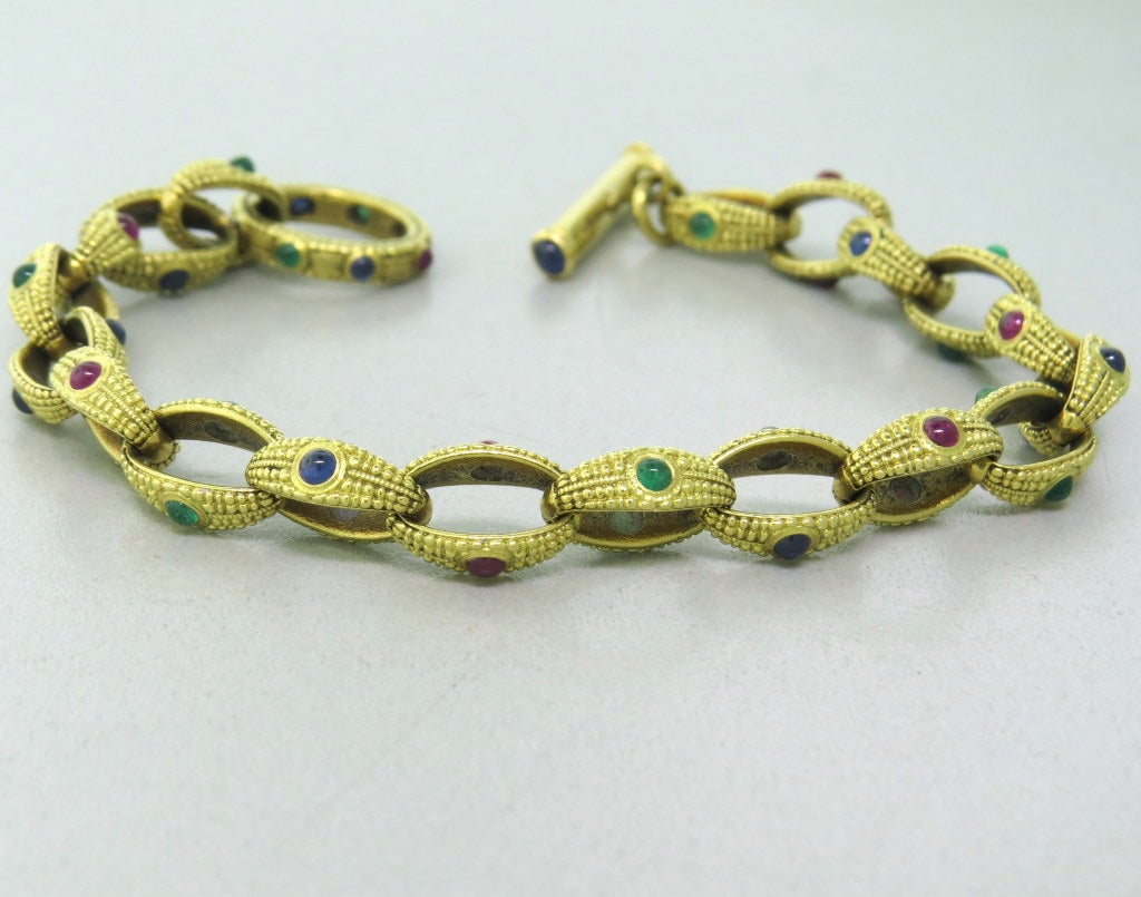 Alex Sepkus 18k gold link toggle bracelet with emerald,ruby and sapphire cabochons. Bracelet is 8 1/2