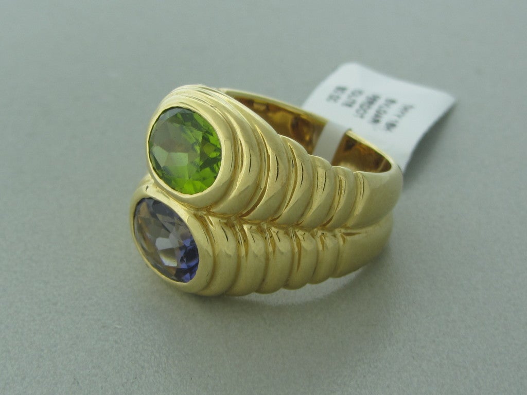 18K Yellow Gold Marked:Bvlgari, 750, Made In Italy, Italian Punchmarks Gemstones/Diamonds:Peridot Iolite Clarity: n/a Color: n/a Measurements:Ring Size 5.75, 17mm Widest Point (Inch = 25mm) Weight:16.7g