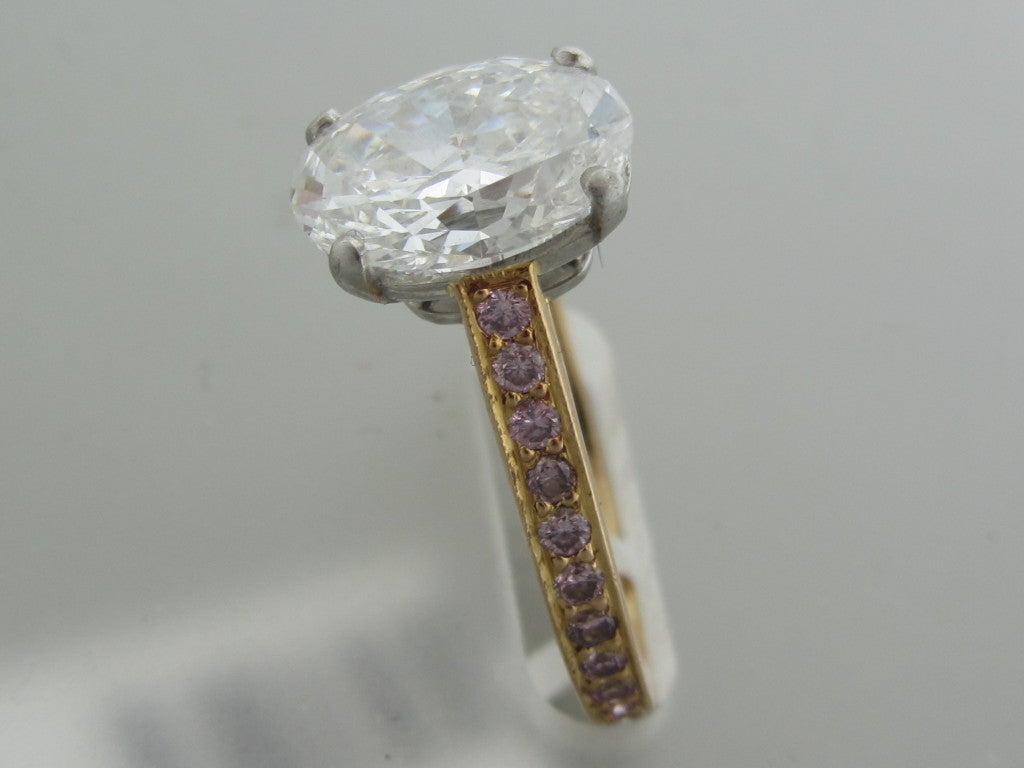 18K Rose Gold Gemstones/Diamonds:Oval Brilliant Cut Diamond - 2.39ct (See GIA Report For Additional Information) Pink Round Diamonds - 0.39ctw Measurements:Ring Size - 6 Marked/Tested: Graff, 2.39ct E VS2 Clarity:VS2 Color:E Weight:3.9g