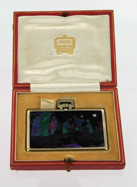 Cartier ladies pocket mirror, Paris circa 1926-27.   Decorated with black lacquered, mother of pearl inlay in a Oriental motif in silver frame and small cabochon moonstone.  Mirror comes in its original Cartier  box.  Rectangular piece measures 1