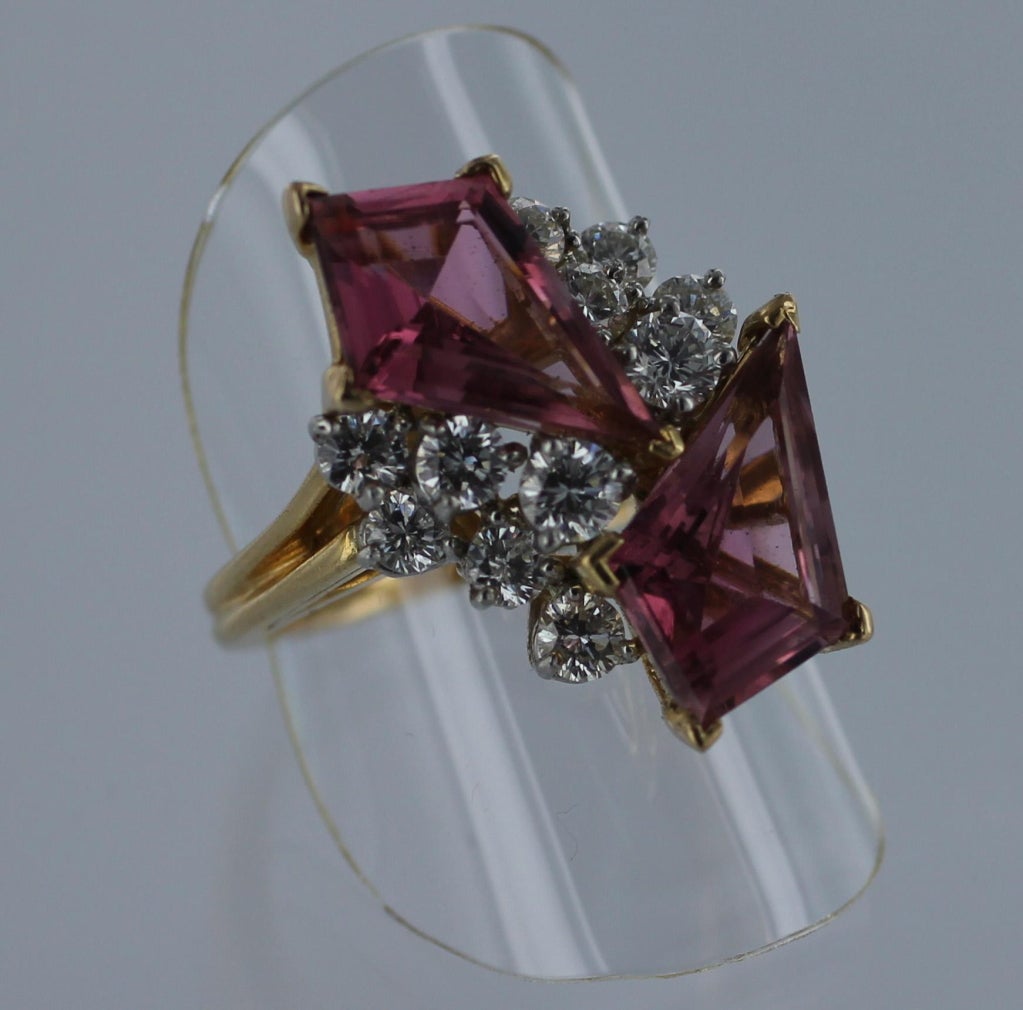 OSCAR HEYMAN Diamond and Pink Tourmaline Ring in platinum and 18-karat gold.  Two kite-shaped pink tourmalines with eleven round brillant diamonds.  The total diamond weight is approximately 2.2 carats.  The ring is sized to 7.25.  Ring bears