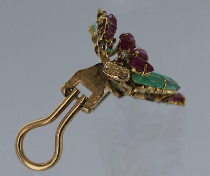 BUCCELLATI Emerald, Ruby and Gold Earrings.  Each earring is  a 18 karat yellow gold floral branch(s) set with carved emerald and ruby leaves.  The earrings measure approximately 1