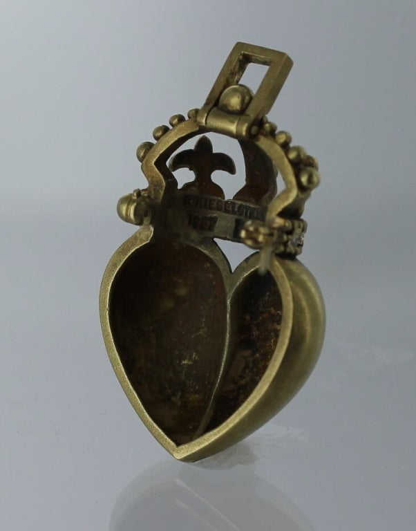 Brooch by Barry Kisselstein-Cord in 18 karat gold with 5 diamonds.  The brooch is a matte gold heart with a crown encrusted with five round brilliant diamonds.  The brooch measures 1 5/8's inch long and 7/8's inch wide.  The brooch bears impressed