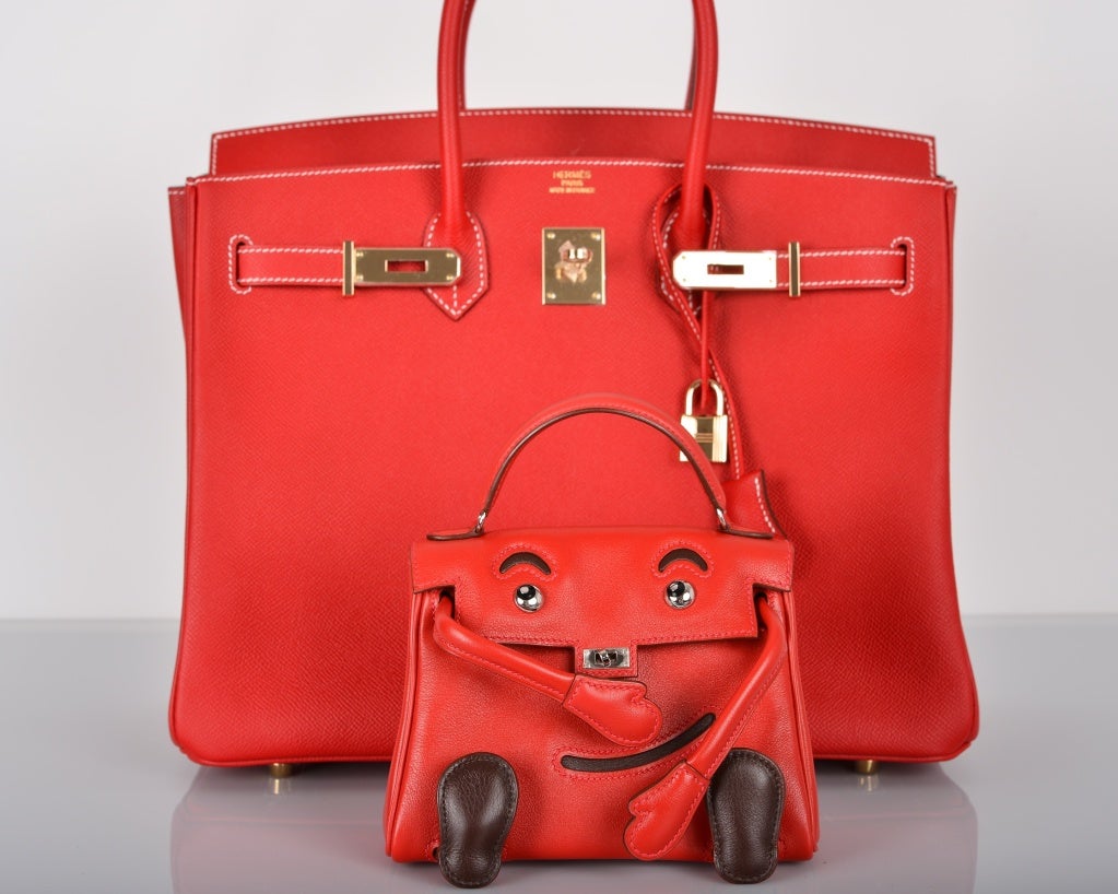 SUPER RARE HERMES KELLY IDOLE KELLY DOLL RED INCREDIBLE COLLECTORS PIECE!

As always, another one of my fab finds... INTRODUCING a very rare Hermes KELLY IDOLE (KELLY DOLL) IN ROUGE VIF GULLIVER LEATHER 

THE STRAP IS BLACK AND WAS NOT PURCHASED