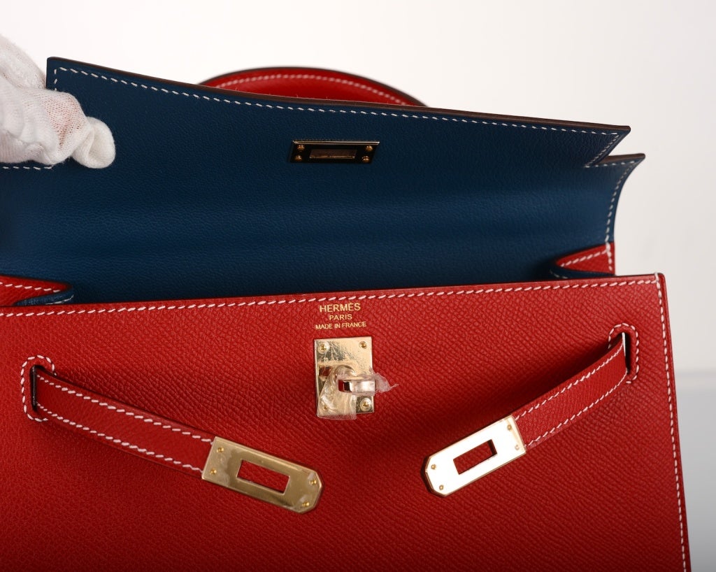 HERMES 25CM Kelly  in epsom leather.  A VERY rare gorgeous JEWEL ROUGE CASAQUE EPSOM WITH BLUE THALASSA INTERIOR AND CONTRAST WHITE STITCHING. Permabrass hardware. BRAND NEW WITH BOX AND ALL ACCESSORIES. This bag is stunning.