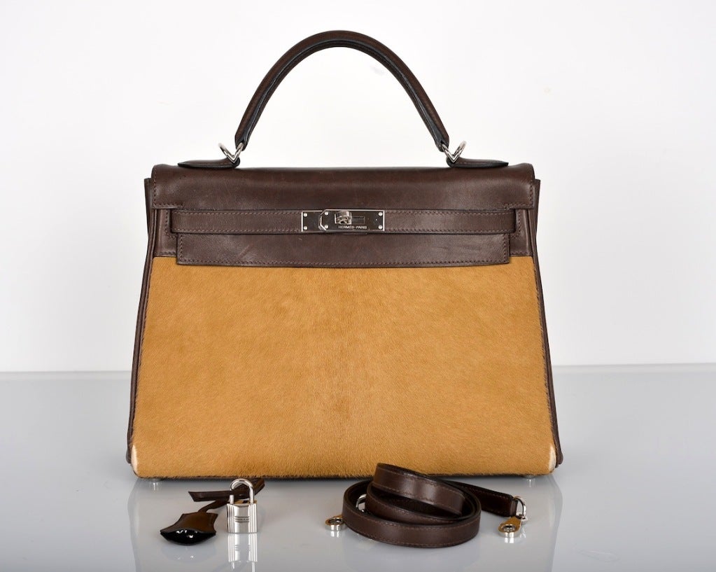ONLY ON JF! HERMES 32CM KELLY LIMITED EDITION PONY HAIR TROIKA GRAB THIS!

As always, another one of my fab finds, Hermes 32cm LIMITED EDITION CAMEL PONYHAIR AND EBENE EVERCALF LEATHER TROIKA RETOURNE KELLY BAG WITH PALLADIUM HARDWARE. IF YOU LOVE