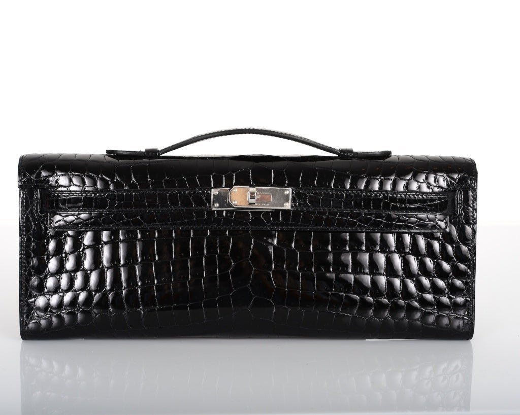 HERMES CROCODILE BAG KELLY CUT CLUTCH POCHETTE BLACK SHINY PALL HARDWARE

As always, another one of my fab finds, CANT GET THIS.. Hermes KELLY CUT IN THE MOST FABULOUS CLASSIC BLACK NILO CROCODILE with PALLADIUM hardware
MEASURES: 12 1/4 x 5