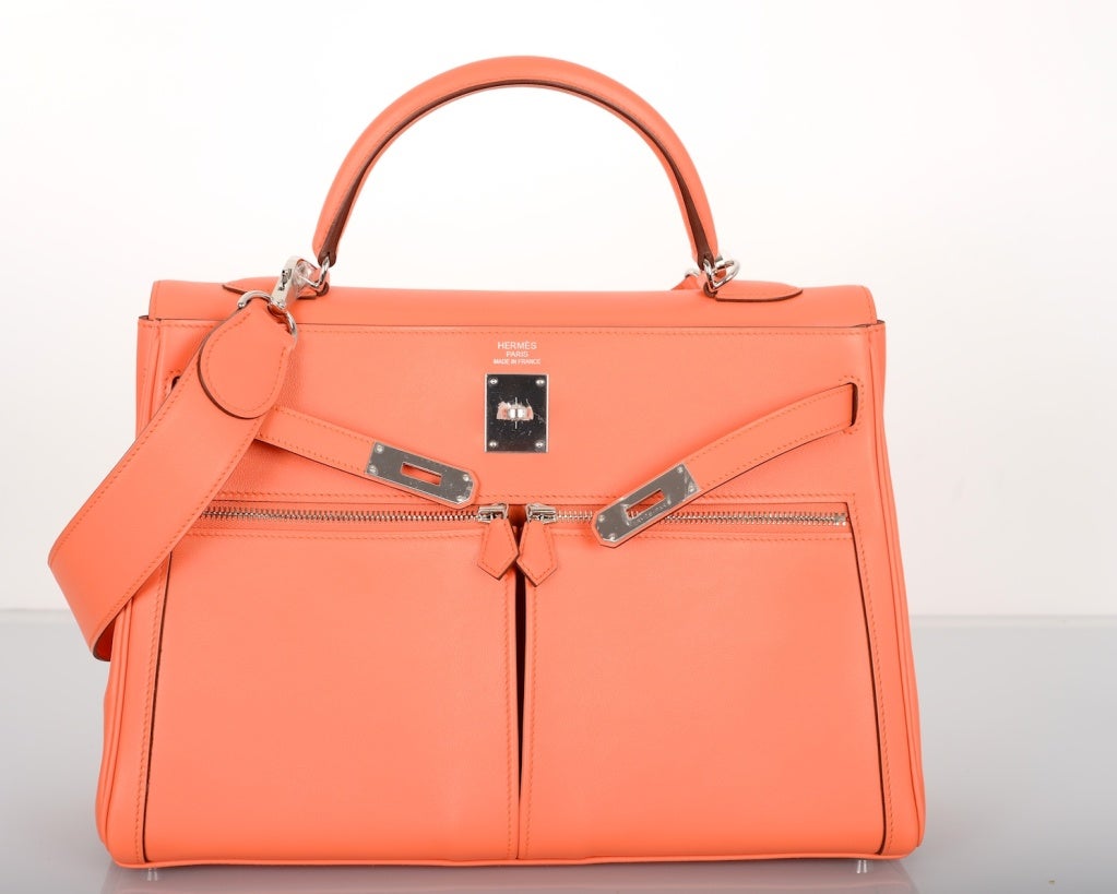 As always, another one of my fab finds, IMPOSSIBLE Hermes 35cm KELLY LAKIS BAG IN GORGEOUS NEW ORANGE MANGUE color WITH amazing all leather WIDE shoulder strap simply to die! 

Beautiful swift leather and palladium hardware.

This bag is brand
