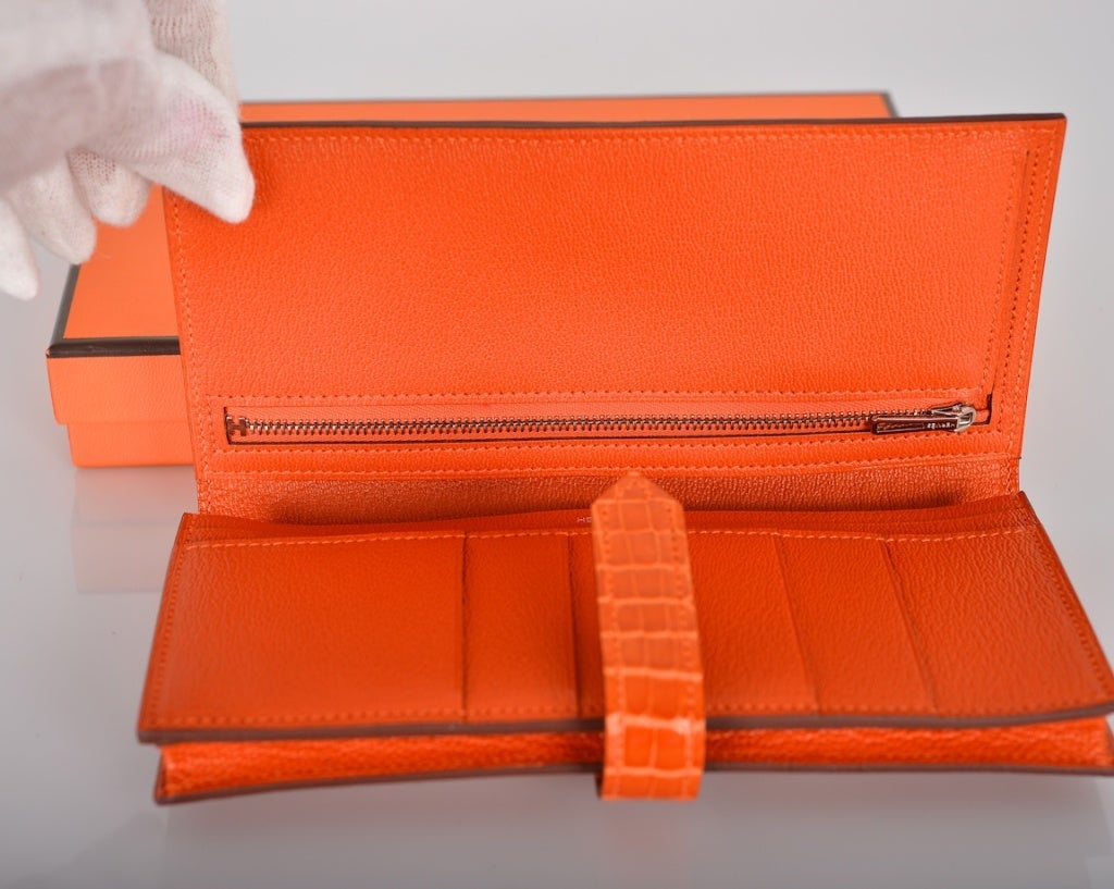 As always, another one of my fab finds, Hermes Crocodile Bearn wallet in GORGEOUS FOREVER CLASSIC ORANGE WITH PALLADIUM HARDWARE!

THE  WALLET IS BRAND NEW COMES WITH BOX AND RIBBON
MEASUREMENTS : 4