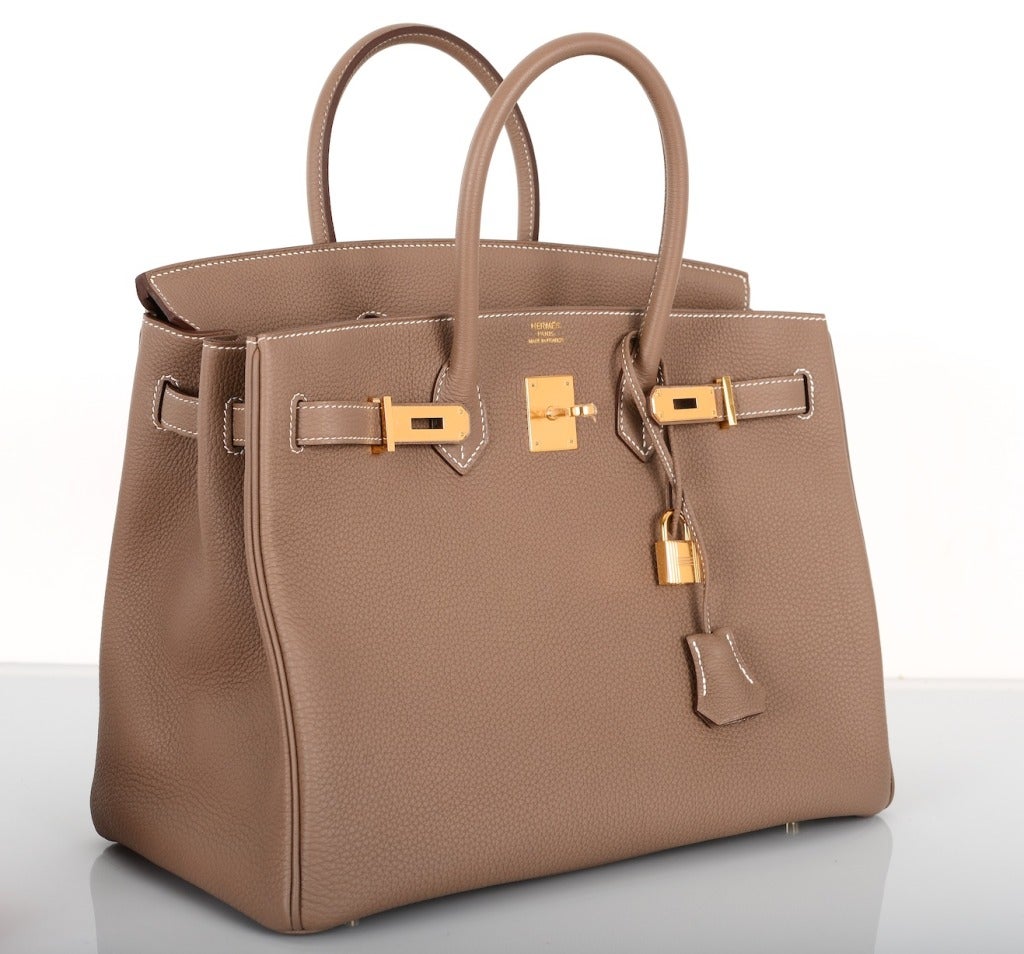 As always, another one of my fab finds! The Hermes 35cm BIRKIN in beautiful TOGO leather in the most beautiful Etoupe color with contrast white stitching. The hardware is gold! Gorgeous! 

This bag comes with lock, keys, clochette, a sleeper for