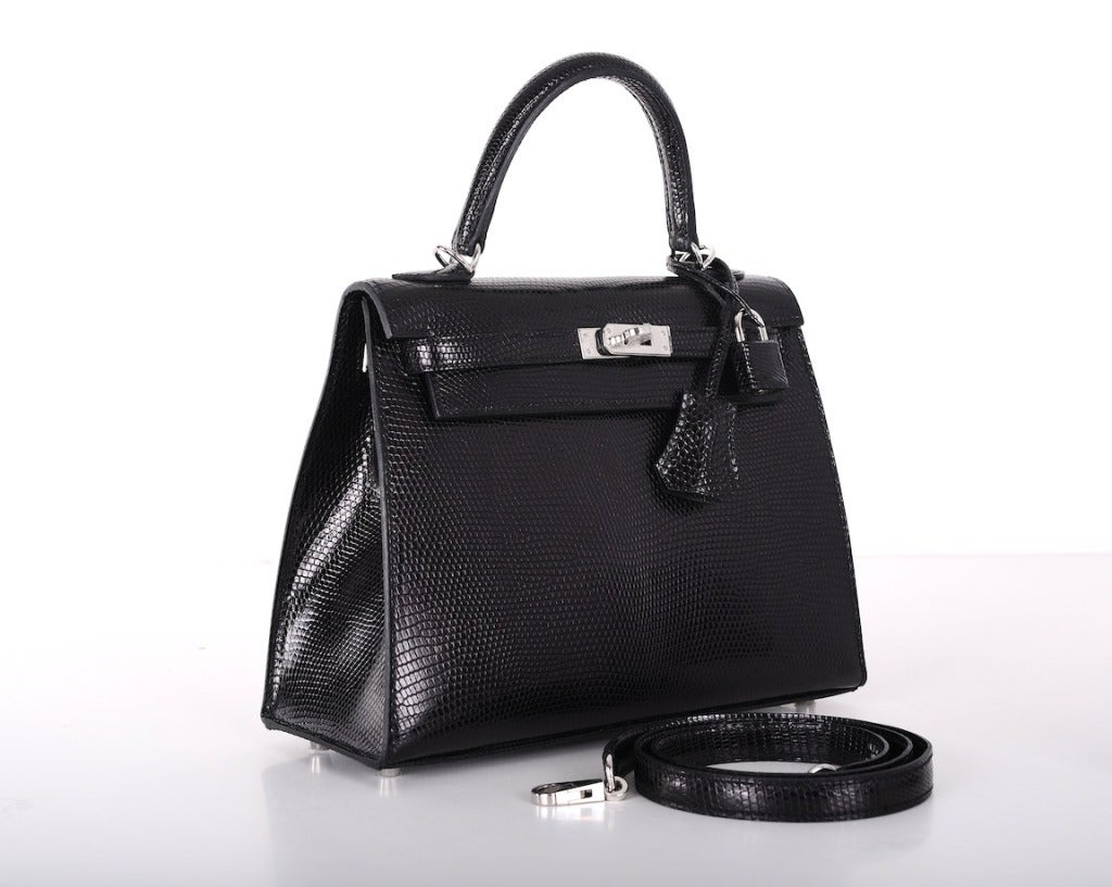 As always, another one of my fab finds! Hermes 25cm KELLY in beautiful IMPOSSIBLE TO GET LIZARD IN GORGEOUS BLACK. THE BAG IS BRAND NEW WITH PLASTIC ON THE HARDWARE.
This bag comes with strap, a sleeper for the bag, and rain protector, and box!