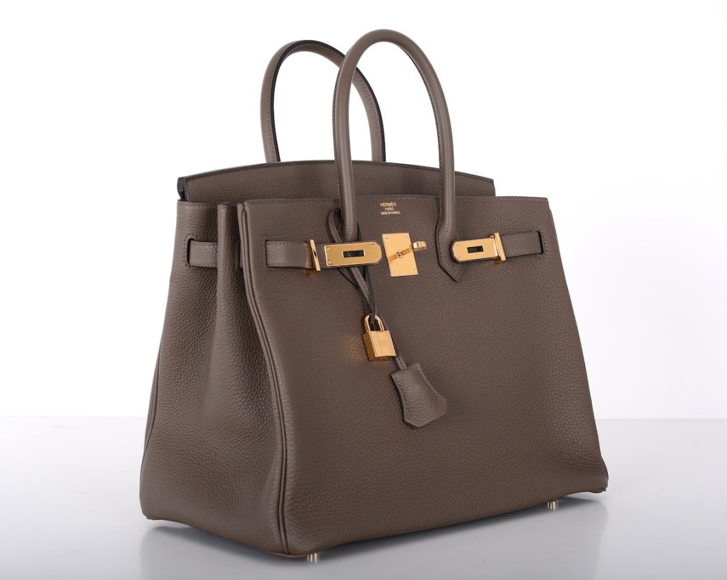 As always, another one of my fab finds! The Hermes 35cm BIRKIN in beautiful TOGO leather in the most beautiful new sophisticated  TAUPE color with contrast white stitching! The hardware is gold! Gorgeous! 

This bag comes with lock, keys,