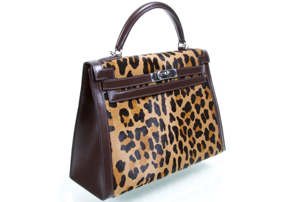 The Kelly bag is THE most famous Hermes bag and this is a one of a kind piece very hard to obtain. It's a celebrity favorite Color: LEOPARD Troika and Dark brown matching leather frame. Incredible and true JaneFinds!

Size: 32cm
Palladium Silver