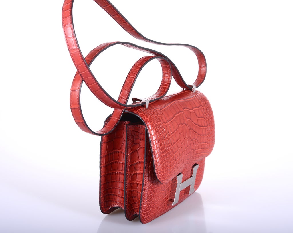 As always, another one of my fab finds! Hermes Constance in ALLIGATOR! A PERFECT size 18cm! Very rare FIND in the ROUGE H WITH PALLADIUM HARDWARE AND AN EXTRA BACK POCKET. Comfy double strap that is perfect to carry cross body! 

Measurements: