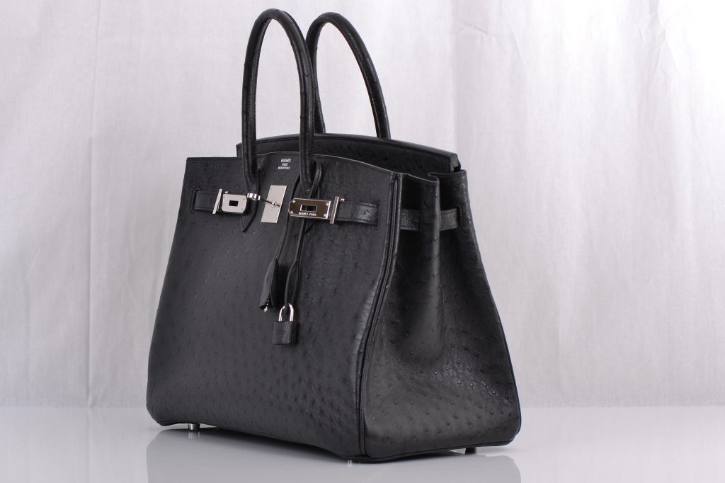 Hermes Birkin Bag 35cm Black Ostrich Palladium Hardware. This is a discontinued size in Ostrich, a must own for a true collector. Near mint condition, no plastic on hardware with a few surface marks on the bottom feet only. Offered to 1stdibs