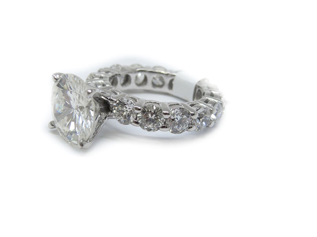 This 18 KT white gold Diamond Engagement Ring, features 3.99 Carat center round shaped diamond ( EGL USA Certified) and surrounded by important round shape diamonds which is goes all the way around the band.

The center diamond looks like 4.25