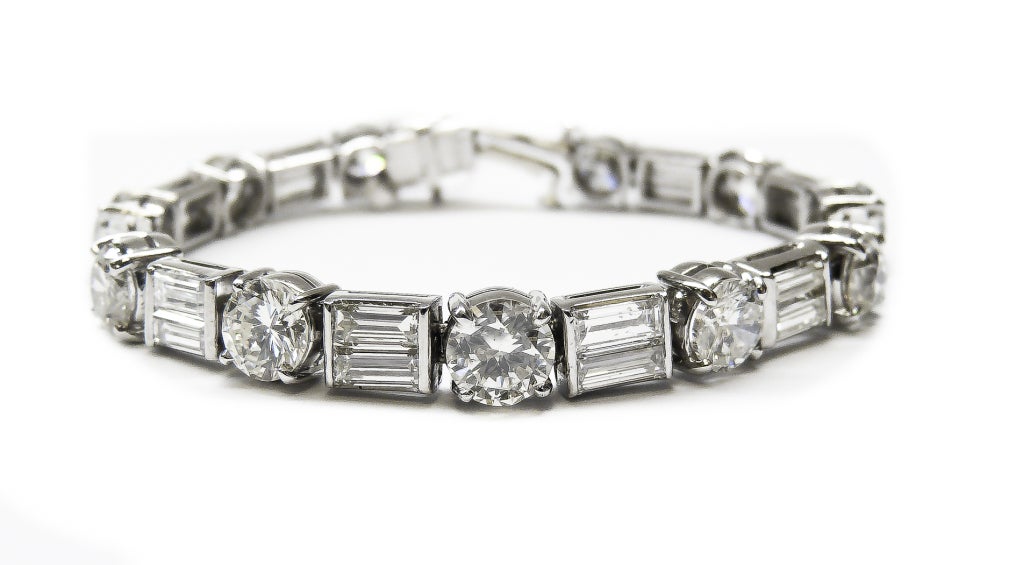 This a remarkable antique bracelet, features 11 bright and rich European Brilliant Cut Diamonds. Each Round shape diamond is weighing approximately 1.00 - 1.15 Carats,which comes up to 11.80 carats.These top quality and color round diamonds set