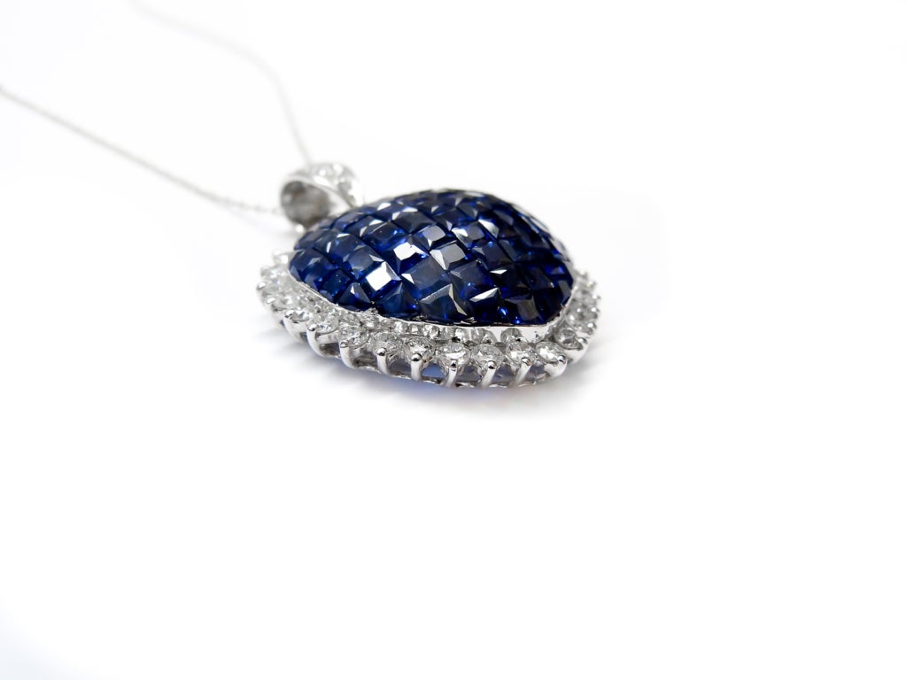 This Stunning Sapphire and Diamond pendant, features 5 Carats of Corn Flower Blue Sapphires, surrounded by 1.50 carats of Round brilliant cut diamonds.
Set in 18K White gold

The diamonds are G/H in Color, SI in Quality