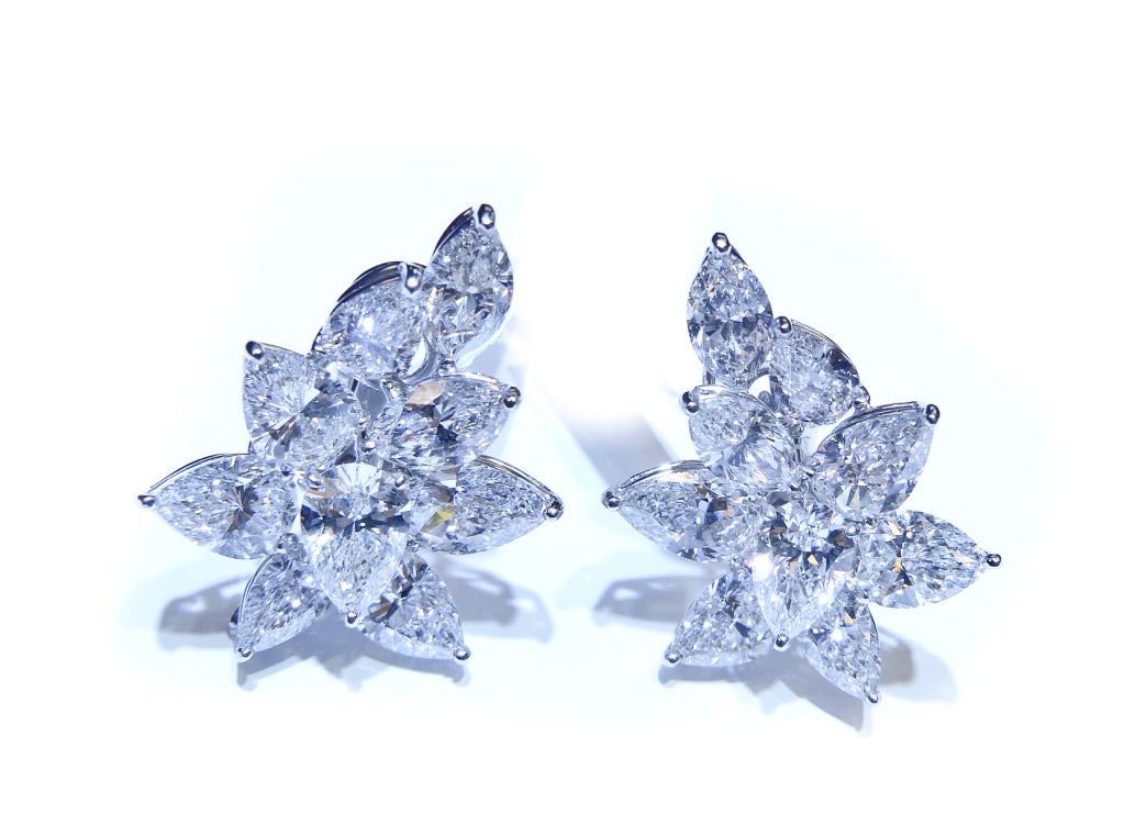 Absolutely stunning and exclusive diamond cluster earrings. 
Features 18 GIA Certified.
14 Pear shape diamonds, weighted 17.38 Carats 

4 Marquie shape diamonds, weighted 4.36 Carats 

Color and Clarity Layout attached.