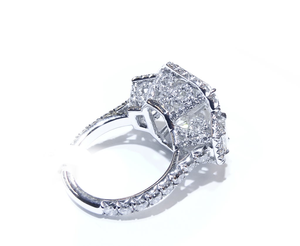 An outstanding Radiant Cut Diamond Engagement Ring. The remarkable, one of a kind, platinum mounting was designed by Diana M. 
The Center diamond is 10.02 K in Color, VS2 in Clarity. GIA Certified. The diamond faces up white. No yellow hue. 
The