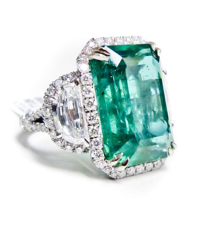 Exquisite 15.86 Carats Natural Green Emerald and Diamond Ring. 
PLATINUM, GIA CERTIFIED EMERALD RING. FEATURES 15.86 CT EMERALD WITH 3.15 CARATS OF DIAMONDS ON THE SIDE. 
Certified by GIA F2