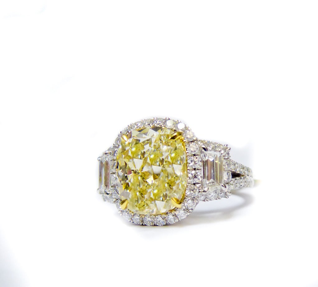 Vibrant diamond ring, the center diamond is 5.01 Carats, Fancy Light Yellow (looks like Fancy Yellow) SI1 in Clarity, set with 2.50 Carats of diamonds on the side. Certified by EGL USA,
Contact us for more information.