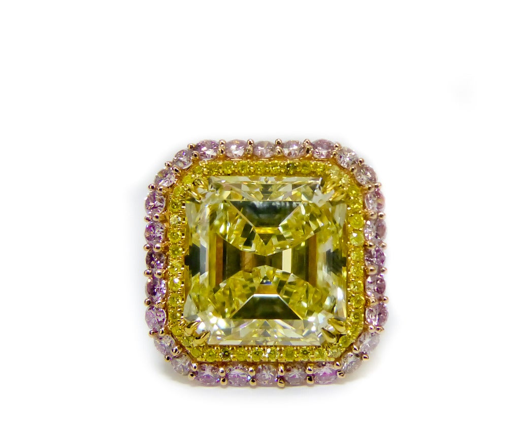 Spectacular Asscher cut diamond ring, the center diamond is 13.00 Carat Fancy Yellow, VVS2 in Clarity Asscher cut diamond, surrounded by 2.50 cts of Natural Fancy Pink and Fancy Yellow diamonds on the side.  
Certified by GIA Laboratory