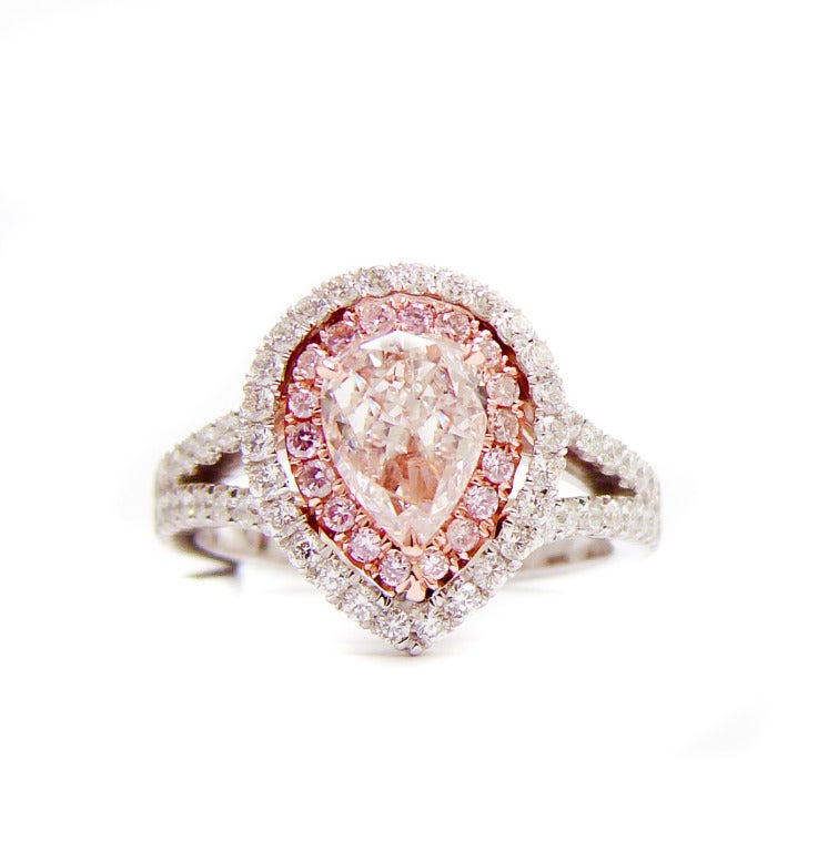 Stunning platinum diamond engagement ring, the center stone 1.01 Carat Fancy Light Pink Pear shape, 0.80 carats of white diamonds and 0.20 carats of fancy pink diamonds.