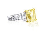 The center diamond is a 10.26 Fancy Yellow Radiant cut 
VS1 clarity.
The total diamond weight of the side trapezoids and micro pave diamonds is 3.85ct.(F/G-VS)