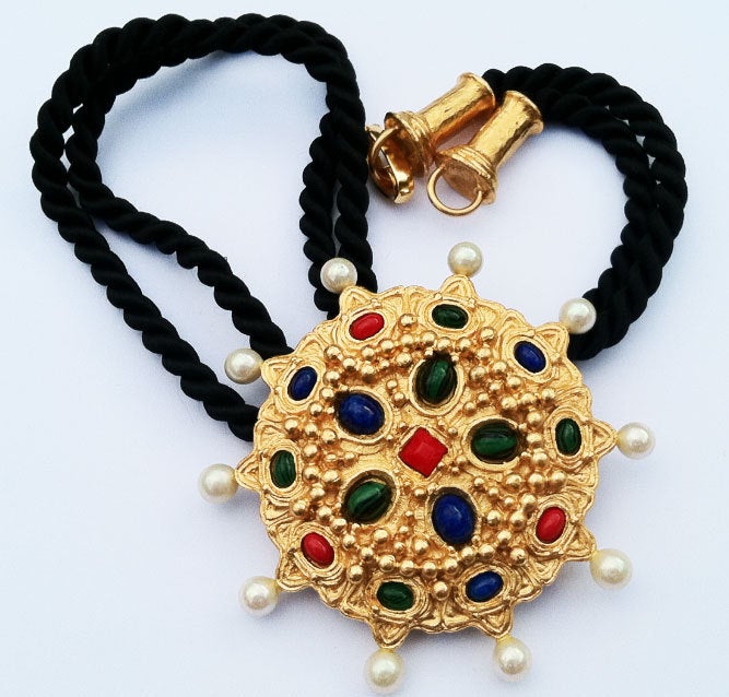 Fine vintage Christian lacroix pendant necklace. Braided black silk item features a gilt metal pendant 'set' with glass cabochons & faux pearls.

*Please contact dealer to purchase or with any questions.