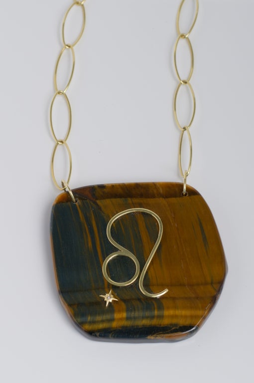 18K Gold and Tiger's Eye Zodiac charm with Princess cut white diamond set in a gold star, shown here in the Leo sign. The charm can be customized with any zodiac sign and is also available in Rose Gold or White Gold. Size of Tiger's Eye may vary
