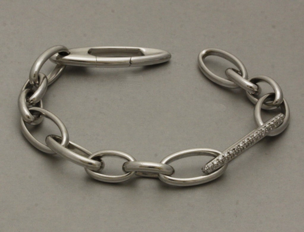 Simple and chic, this Pomelatto bracelet features oval 18K white gold links and is accented with a longer central link set with pave diamonds. Bracelet length is adjustable by closing the clasp on different links.