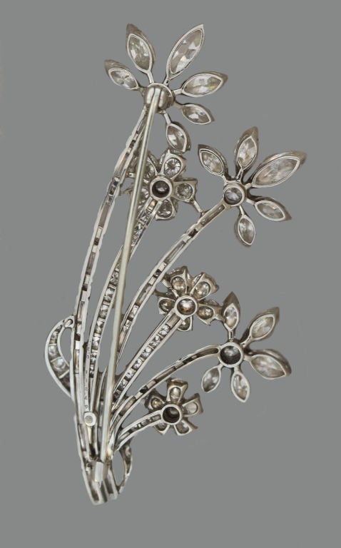 Classic Heyman Brothers workmanship can be seen in this exquisite diamond-set spray of flowers in platinum. Marquise and round-cut diamonds form the petals of this 1950?s brooch, with the stems built from a combination of round stones and baguettes.